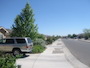 View down the street of the nicely landscaped gated community from the front sidewalk of the home.