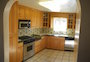 Panoramic of kitchen from dining room.