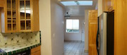 View of kitchen from the sunroom (washwer and dryer are behind the closet doors to the left)